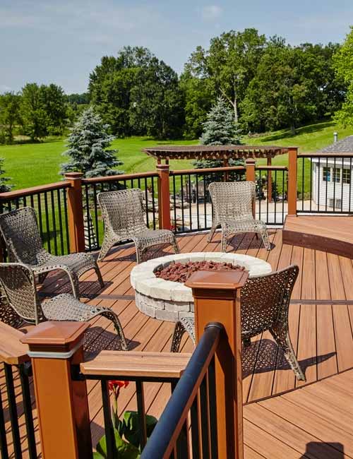 Wooden deck with chairs around a fireplace